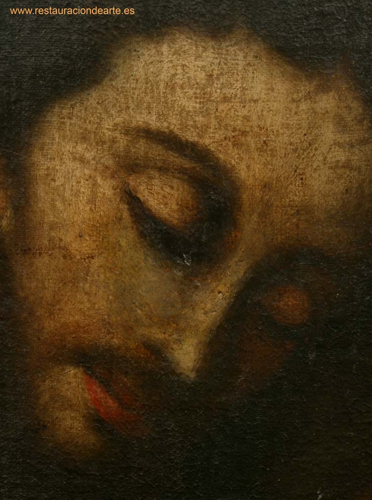 Detalle de la cara de San José, oculta tras el grueso barniz oxidado, antes de la restauración